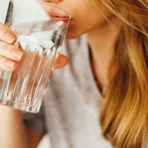 A woman drinking a glass of water